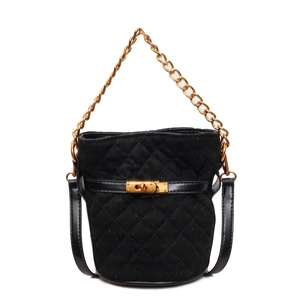 Quilted black suede bucket bag with gold chain handle and leather strap on white background