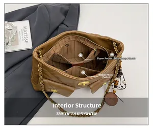 Detail view of the brown quilted chain bag interior with organized compartments and striped lining