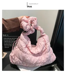 Detail view of pink quilted nylon cloud bag with scrunchie handle and metal zipper
