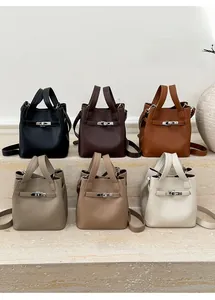 Group of six minimalist pebbled leather bucket bags in various neutral autumn colors