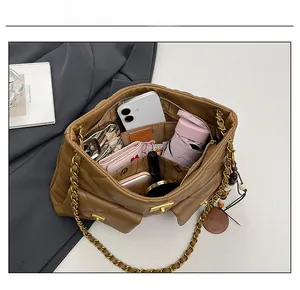 Top view showing the spacious interior and compartments of the brown quilted tote bag