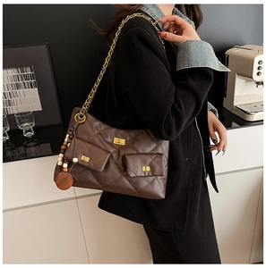 Détail du sac cabas matelassé marron foncé avec bandoulière chaîne et poches à fermoir doré