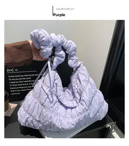 Detail of light purple quilted nylon puffer shoulder bag with a scrunchie style handle