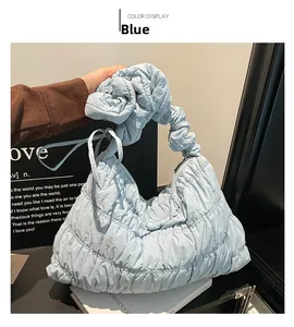 Detail of light blue pleated nylon cloud bag featuring ruffles and metallic zipper