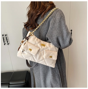 Detail of off-white quilted shoulder bag featuring gold chain straps and dual front pockets