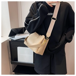 Detail of light apricot textured leather shoulder bag with wide strap for work