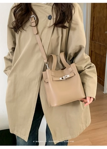 Detail of khaki bucket bag with silver metal swivel lock and fine leather texture