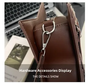 Macro shot of silver hardware accessories and stitching on the dark brown star-shaped bag