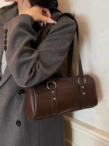Minimalist dark brown cylinder handbag with silver rivets and dual shoulder straps