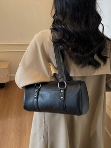 Minimalist black leather barrel shoulder bag for women with silver metal rings and rivets