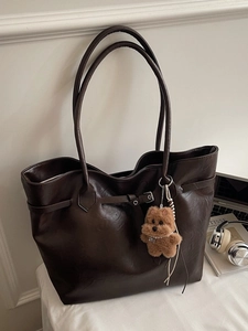 Classic dark brown tote bag in faux leather with teddy bear charm for daily commute