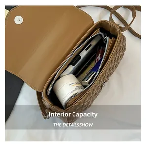 Internal view of brown crossbody bag showing spacious compartments for cosmetics