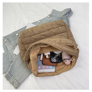 Detailed interior view of a quilted puffer tote bag showing its large storage capacity