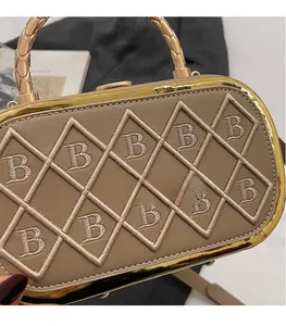 Detail of khaki leather handbag with B-letter embroidery and golden metal handle