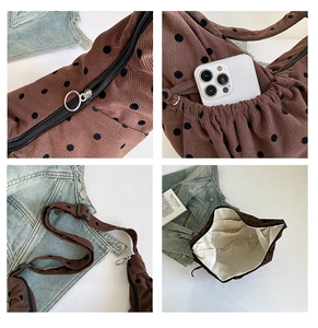 Detail view of brown polka dot corduroy tote with metal ring zipper and side pockets