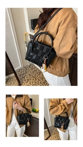 Detail of black woven checkered tote bag with tassel charm and detachable strap