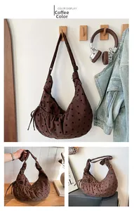 Detail view of coffee polka dot corduroy hobo bag with adjustable strap and drawstring sides