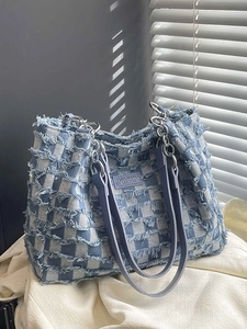 Blue and white checkered denim tote bag with frayed fringe edges and silver chain strap
