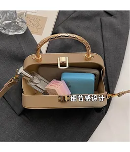 Interior view of khaki crossbody bag showing storage space for phone and makeup