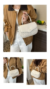 Detail of cream flap handbag showing woven texture, round handle, and styling options