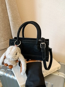 Chic black faux leather handbag with cute rabbit pendant and adjustable strap
