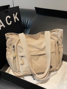 Minimalist beige nylon tote bag with large capacity and multi-pocket design for commuting