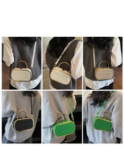 Detail view of retro patchwork square bags in four colors styled with a casual sweater