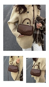 Detail of dark brown leather crossbody bag featuring woven texture and crossbody strap
