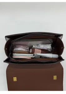Internal view of dark brown handbag showing spacious capacity with everyday essentials