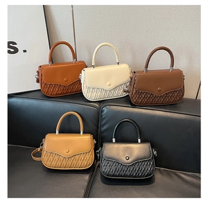 Detail of five stylish crossbody bags featuring unique woven textures and leather flaps