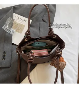 Detail of spacious dark brown bucket bag interior with organized multi-compartment storage
