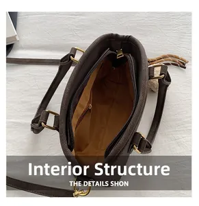 Top view showing the spacious interior compartment and zippered pocket of the brown handbag