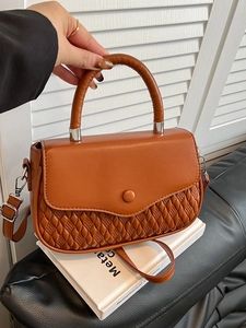 Cognac quilted crossbody bag with top handle and silver buckle for a vintage look