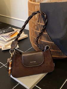 Vintage brown shoulder bag with woven strap and retro beaded pendant decoration