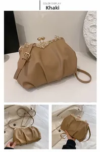 Detail of khaki pleated cloud bag featuring an elegant floral rhinestone metal clasp