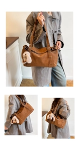 Detailed view of brown PU shoulder bag with soft plush bunny charm and adjustable straps