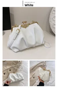 Detail of white ruched shell bag with vintage gold metal frame and crystal floral clasp