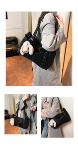 Detail of matte black tote bag featuring an adjustable strap and a cute plush rabbit charm