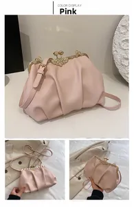 Detail of pink pleated cloud bag featuring crystal bow clasp and gold metal frame finish