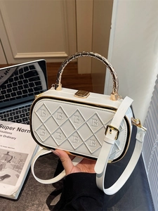 White patchwork quilted box bag with gold metal handle and logo B embroidery