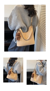 Detail of minimalist beige tote bag with plush bear charm and silk scarf handle decor