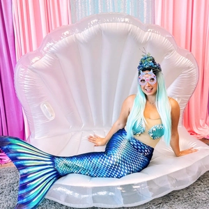 Detail of mermaid shell floaty with children's party glasses and tail costume set
