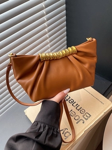 Minimalist brown pleated cloud clutch bag with elegant golden spiral metal handle