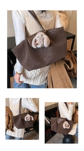 Detail view of large brown leather tote bag with a cute fluffy rabbit charm decoration