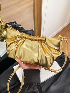 Metallic gold pleated pouch bag with thin leather strap for 2025 winter fashion