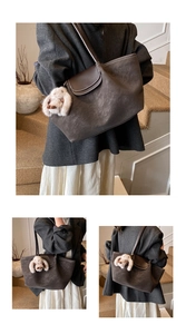 Detail view of retro brown matte tote bag with contrast stitching and plush bunny charm
