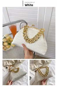 Detailed view of a white pleated cloud bag with elegant gold chain and vintage clasp