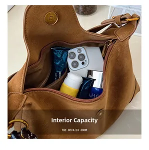 Internal capacity of the dark brown suede crossbody bag showing the inner zipper pocket