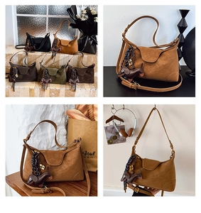 Detail of four retro suede half-moon bags with dachshund charm and braided rope