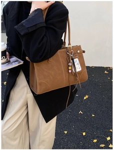 Detail of caramel faux leather tote bag with unique stitched corners and colorful beads